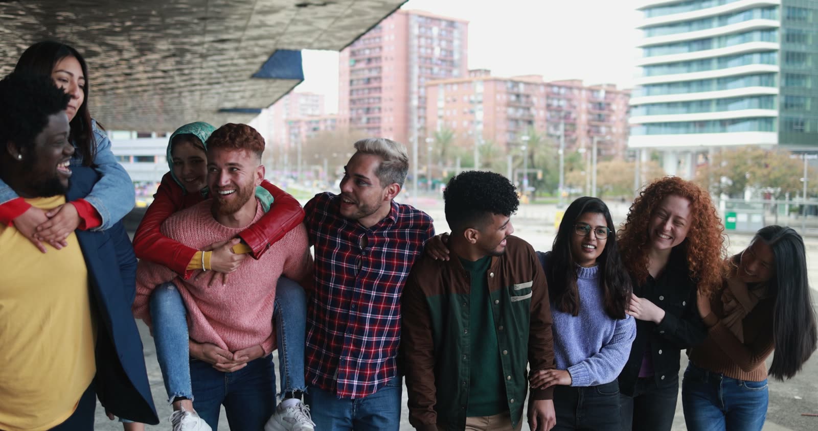 A group of friends walking and laughing in the city